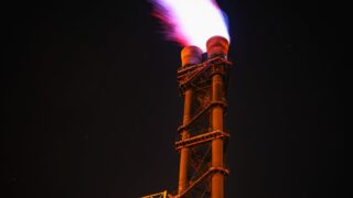 low angle view of illuminated tower against sky at night